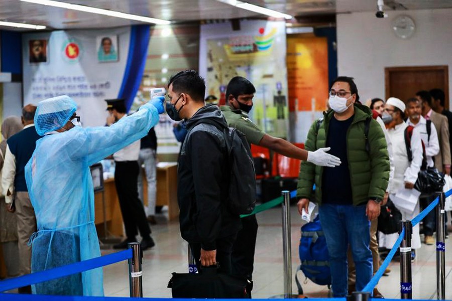 Passengers are checked with a thermal scanner at the Hazrat Shahjalal International Airport in Dhaka, Bangladesh, March 11, 2020. Reuters