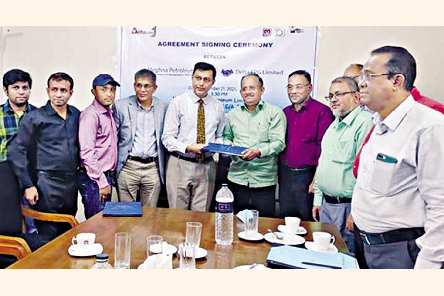 Managing Director of Meghna Petroleum Ltd Saifullah Al Khaled and Executive Director of Delta LPG Ltd Sabbir Ahmed exchanging documents after signing the agreement on behalf of their respective organisations at Meghna Petroleum's head office at Agrabad in the port city on Thursday