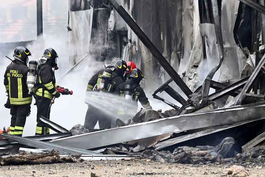 Firefighters working at the spot where a small plane crashed into a building in Italy on Sunday –Reuters photo