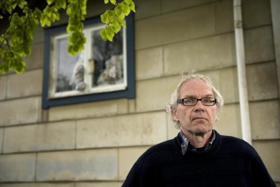 Swedish artist Lars Vilks poses beside his damaged kitchen window at his home outside Hoganas, Sweden on May 16, 2010 — Reuters/Files