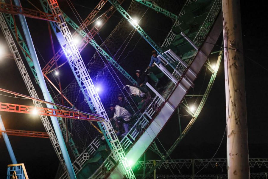 Taliban fighters sit on a ride as they take a day off to visit the amusement park at Kabul's Qargha reservoir, at the outskirts of Kabul, Afghanistan October 8, 2021. Picture taken October 8, 2021. REUTERS/Jorge Silva