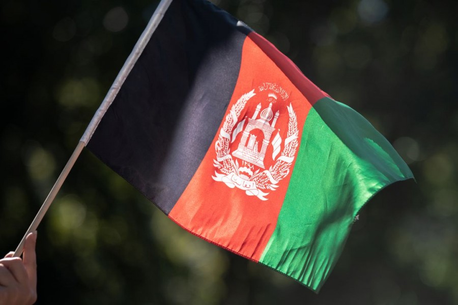 A person holds a flag of Afghanistan while taking part in a Solidarity With Afghan Women rally outside the United Nations headquarters, during the 76th Session of the UN General Assembly, in New York, US, September 25, 2021. REUTERS/Jeenah Moon