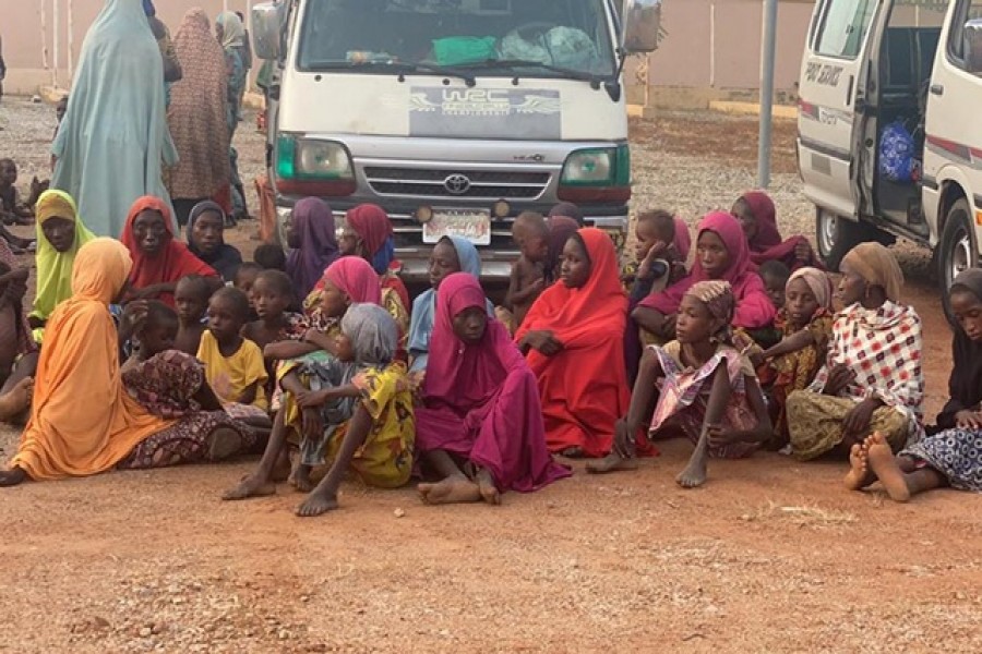 Women and children who were kidnapped in the northwestern state of Zamfara sit after being rescued by the Nigerian security agents in Zamfara, Nigeria Oct 7, 2021. REUTERS