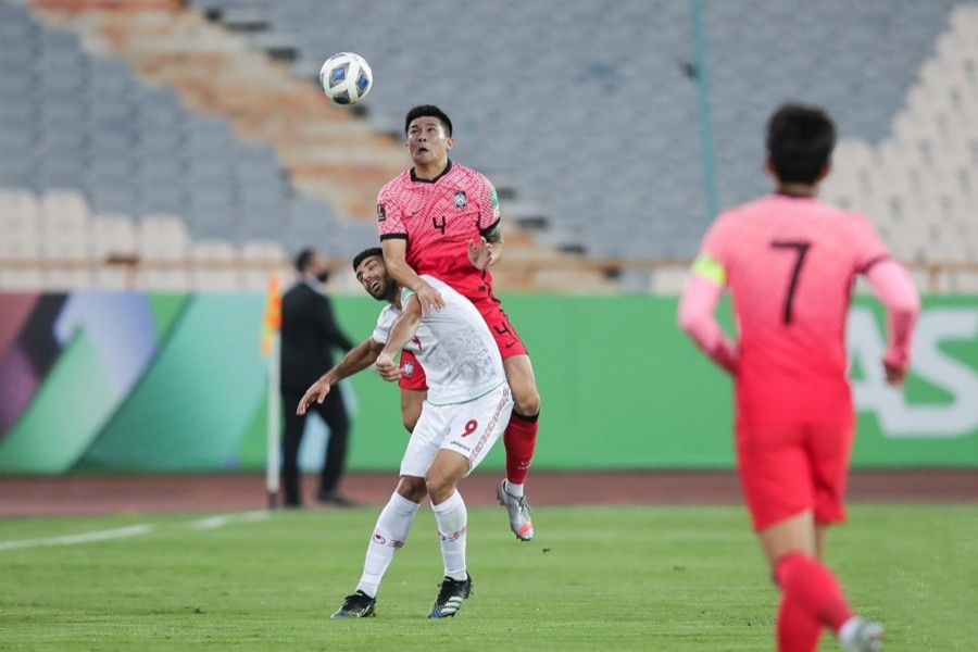 Kim Min-jae of South Korea (cntre) battles with Mehdi Taremi of Iran for the ball during the teams' Group A match in the final Asian qualifying round for the 2022 FIFA World Cup at Azadi Stadium in Tehran on October 12, 2021, in this photo provided by the Korea Football Association — via Yonhap News Agency