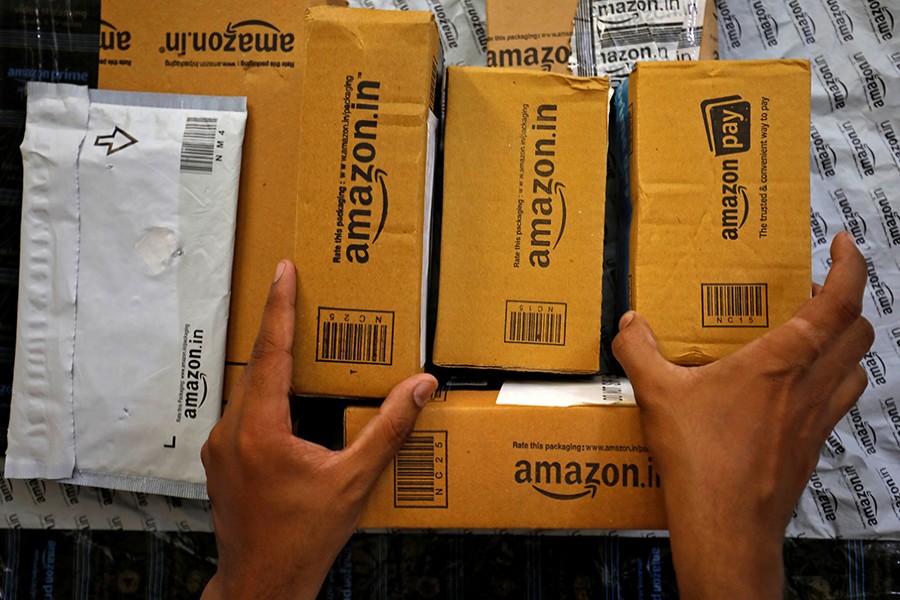 A worker sorts packages for delivery in a van outside an Amazon facility in the Indian city of Ahmedabad earlier this year — Reuters/Files