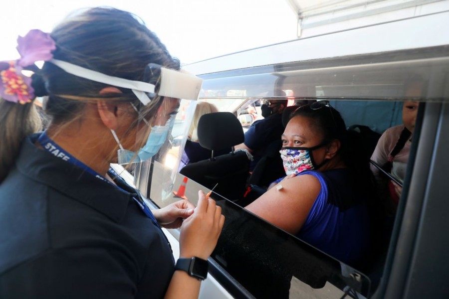 A member of the public receives a Pfizer vaccine at a drive-through coronavirus disease (Covid-19) vaccination clinic in Otara during a single-day vaccination drive, aimed at significantly increasing the percentage of vaccinated people in the country, in Auckland, New Zealand on October 16, 2021 — Retuers/Files