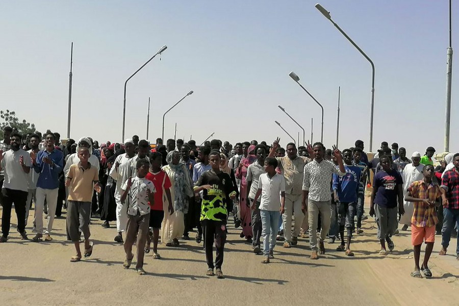 Sudanese demonstrators march and chant during a protest against the military takeover, in Atbara, Sudan on October 27, 2021 in this social media image — Ebaid Ahmed via REUTERS