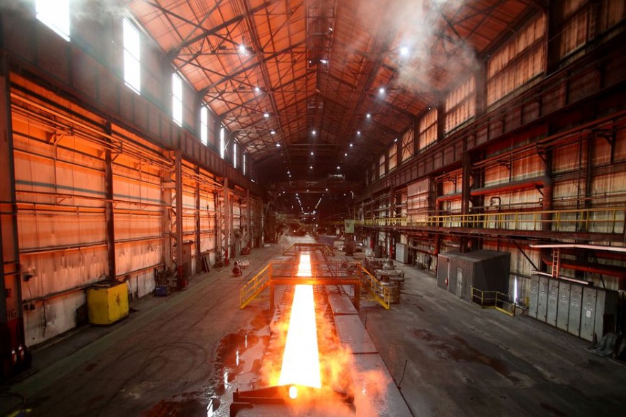 Steam rolls off a slab of steel as it rolls down the line at the Novolipetsk Steel PAO steel mill in Farrell, Pennsylvania, US, March 9, 2018. REUTERS/Aaron Josefczyk/File Photo