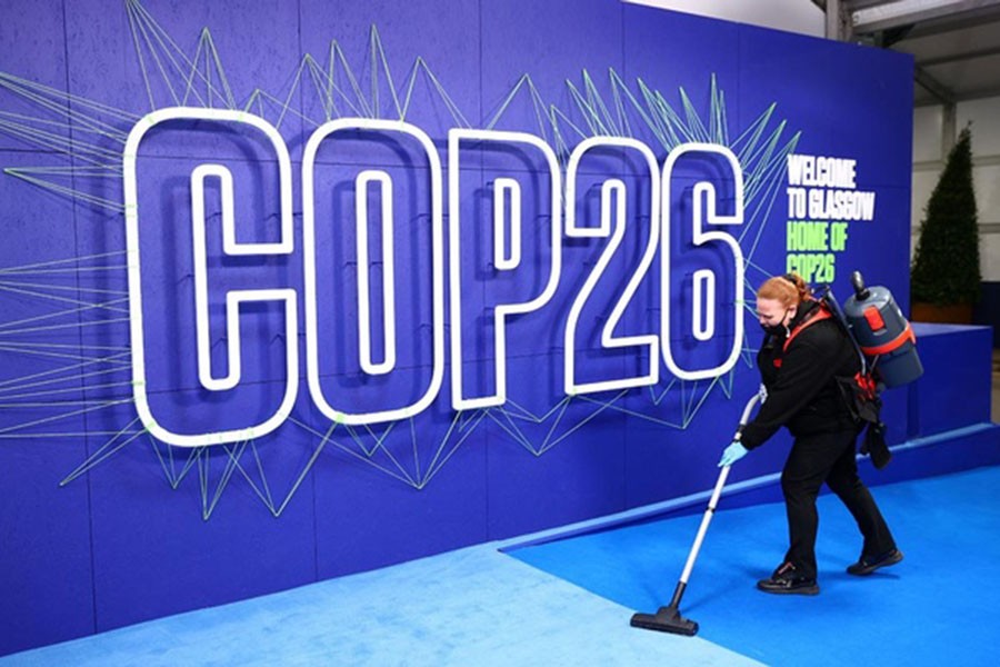 An employee cleans before the arrival of leaders for the UN Climate Change Conference (COP26) in Glasgow, Scotland, Britain November 1, 2021. Adrian Dennis/Pool via REUTERS