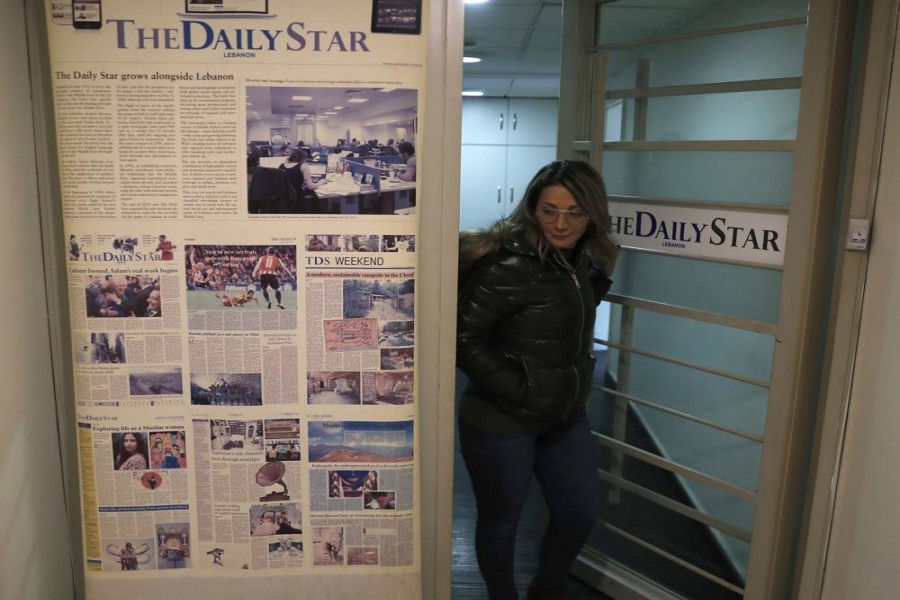 An employee of The Daily Star newspaper opens the main door of the newspaper office, in Beirut, Lebanon, Tuesday, Feb. 4, 2020.  Photo: AP