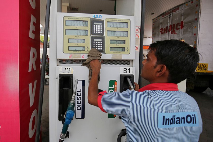 A worker cleans a pump at a fuel station in Ahmedabad, India on May 14, 2018 — Reuters/Files