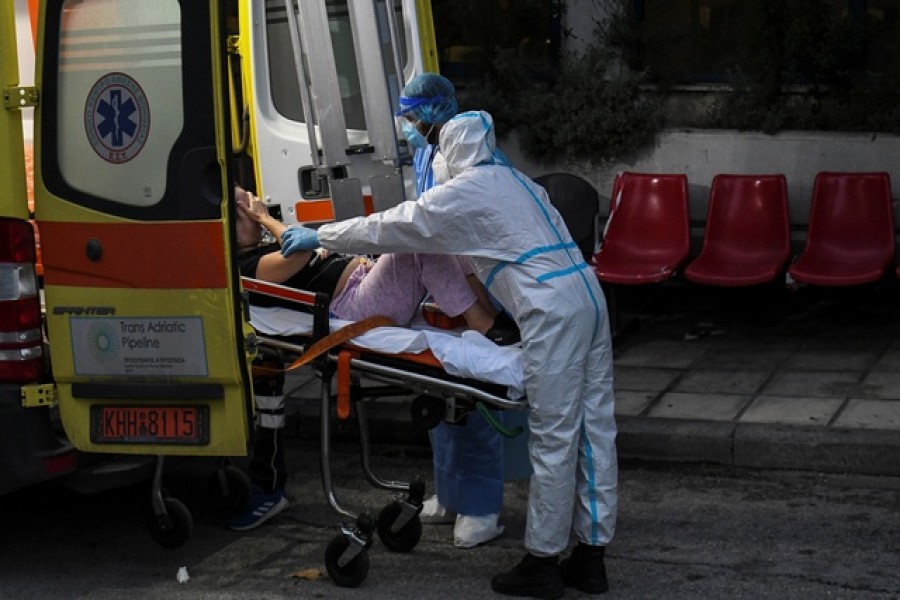 Medical workers wearing personal protective equipment carry a patient on a stretcher, as she arrives on an ambulance at the coronavirus disease (Covid-19) ward of the Ippokrateio General Hospital in Thessaloniki, Greece, November 3, 2021 – Reuters/Files