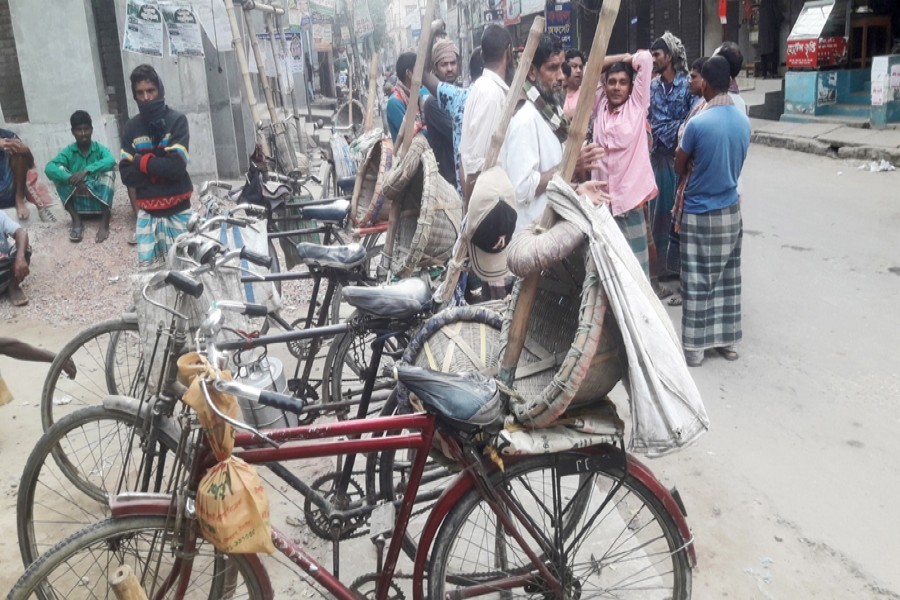 Photo shows a group of day labourers waiting for work on Mashjid Road in Tangail — FE Photo