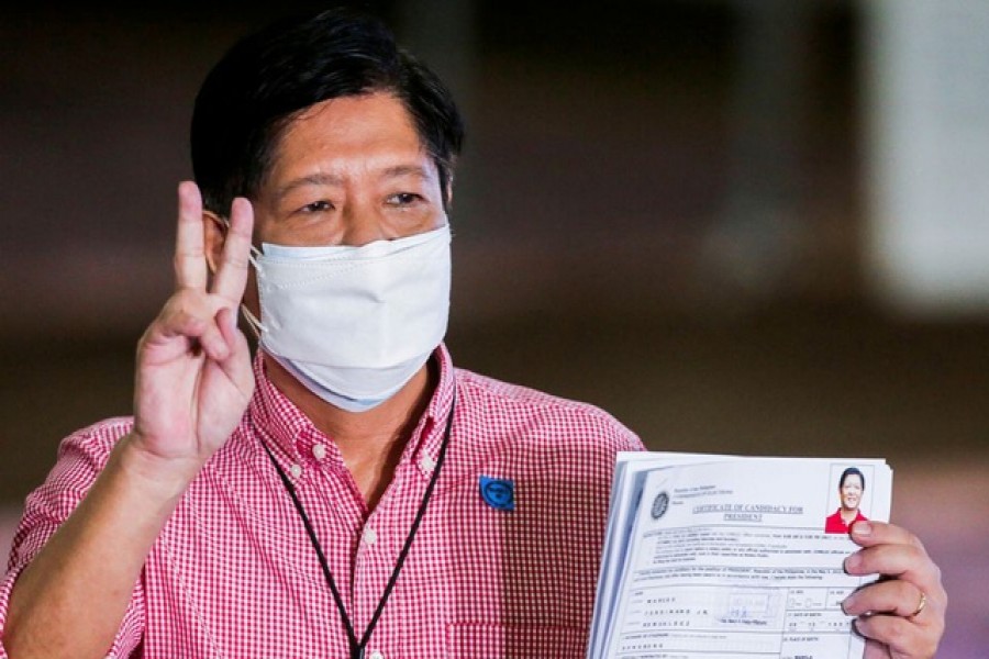 Ferdinand Marcos Jr, the son of late Philippines dictator Ferdinand Marcos, poses for pictures after filing his certificate of candidacy for president in the 2022 national election, in Pasay City, Metro Manila, Philippines, October 6, 2021. Rouelle Umali/Pool via Reuters