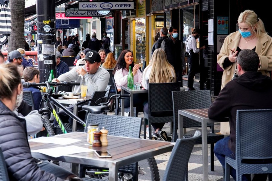 Diners eat outside St Kilda's Rococo restaurant on the second day of eased coronavirus disease (Covid-19) regulations, following a lockdown to curb an outbreak, in Melbourne, Australia on October 23, 2021 — Reuters/Files