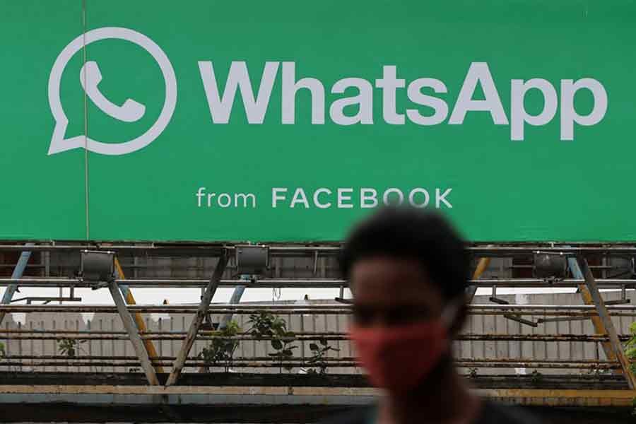 A man walking past a hoarding of the WhatsApp application installed at a skywalk in Mumbai on August 26 this year –Reuters file photo