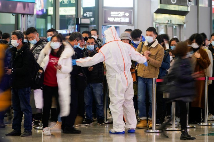 A security guard blocks an exit as he directs people to scan a QR code to track their health status at Shanghai Hongqiao Railway Station, following new cases of the coronavirus disease (Covid-19), in Shanghai, China on November 25, 2021 — Reuters photo