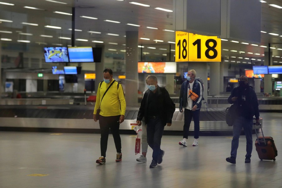 People walk inside Schiphol Airport after Dutch health authorities said that 61 people who arrived in Amsterdam on flights from South Africa tested positive for Covid-19, in Amsterdam, Netherlands on November 27, 2021