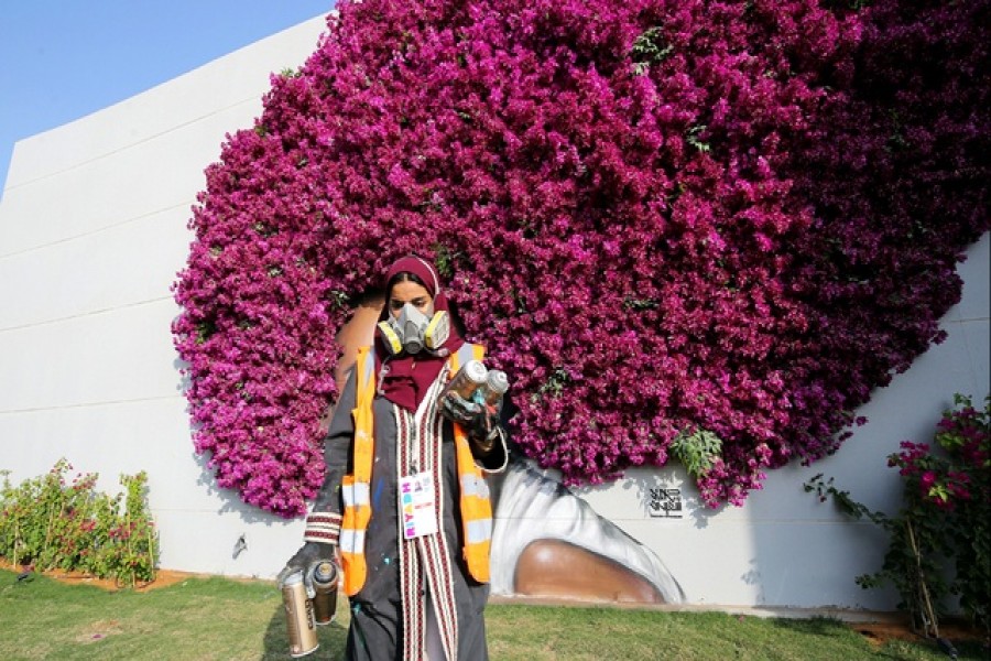 Saudi Mural Artist, Noura Bint Saidan holds bottles of paints during the "Riyadh Season" festival on the Boulevard in Riyadh, Saudi Arabia Nov 23, 2021. REUTERS/Ahmed Yosri