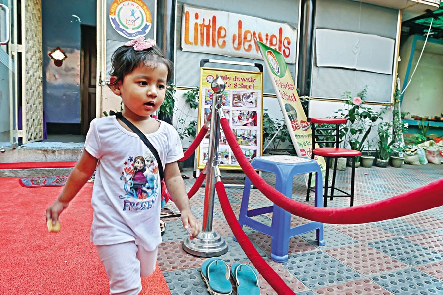 This little kid is coming out of a school right after classes in the Tikatuli area of Dhaka. With the Covid situation improving gradually, students have started to return to schools these days. The photo was taken recently — FE photo by Shafiqul Alam