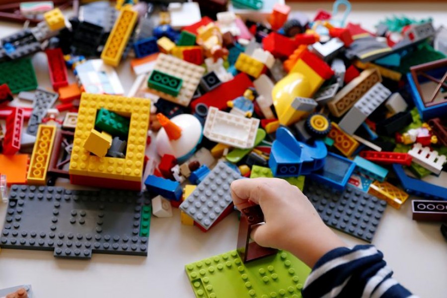 FILE PHOTO: Sirio Persichetti, a 7-year-old Italian with spastic tetraplegia and cerebral palsy who has become an influencer by challenging perceptions of disability, builds a house out of lego, in Rome, Italy, October 20, 2020. REUTERS/Yara Nardi/File Photo