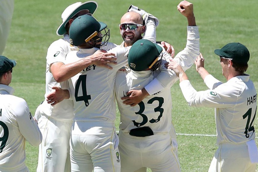 Australia's Nathan Lyon celebrates taking his 400th test wicket during day four of the First Ashes Test — AAP via REUTERS