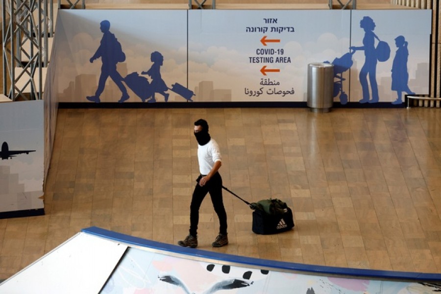 A traveller walks at Ben Gurion International Airport near Tel Aviv, Israel November 28, 2021 – Reuters/Files