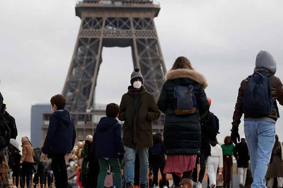 People, wearing protective face masks, walking on Trocadero square near the Eiffel Tower in Paris amid the coronavirus disease (COVID-19) outbreak in France on December 6 this year -Reuters file photo
