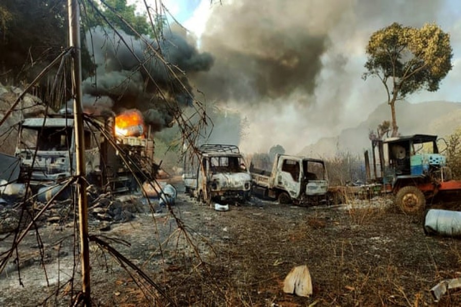 Burned-out vehicles near Hpruso township on Christmas Eve. Photograph: AP