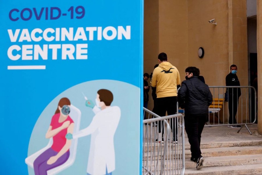 People wearing protective masks queue for booster injections of a coronavirus disease (Covid-19) vaccine as the pandemic continues, at a vaccination centre at the University of Malta in Tal-Qroqq, Malta on December 29, 2021 — Reuters photo