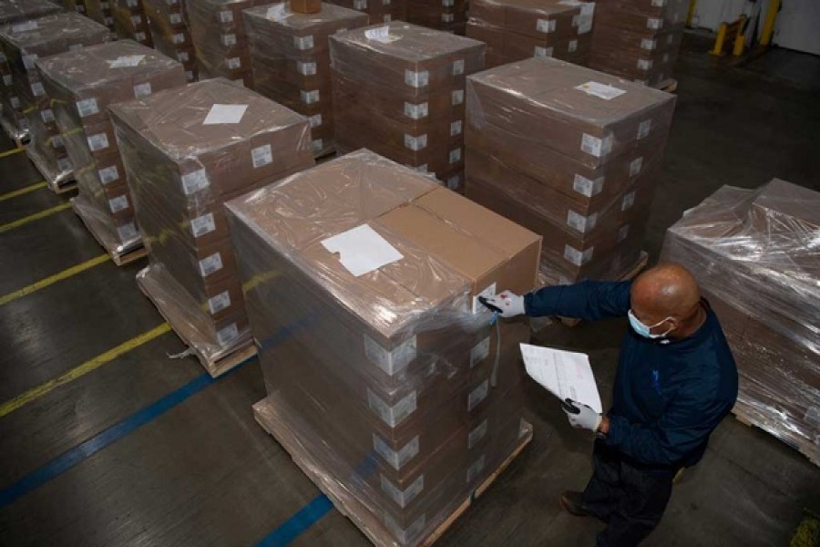 A Pfizer employee checks the boxes containing COVID-19 treatment pills, Paxlovid, at a distribution facility in Memphis, Tennessee, US.