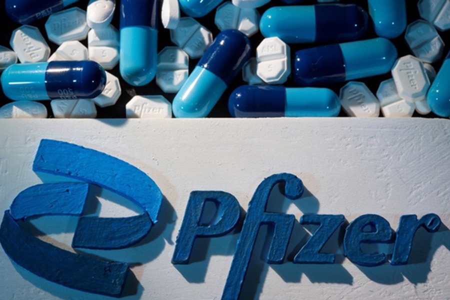 A 3D printed Pfizer logo is placed near medicines from the same manufacturer in this illustration taken Sept 29, 2021. REUTERS/Dado Ruvic