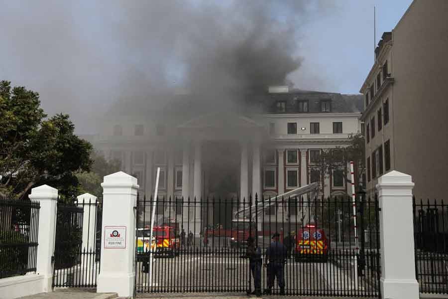 Firefighters working among the smoke after a fire broke out in the Parliament in Cape Town -Reuters photo