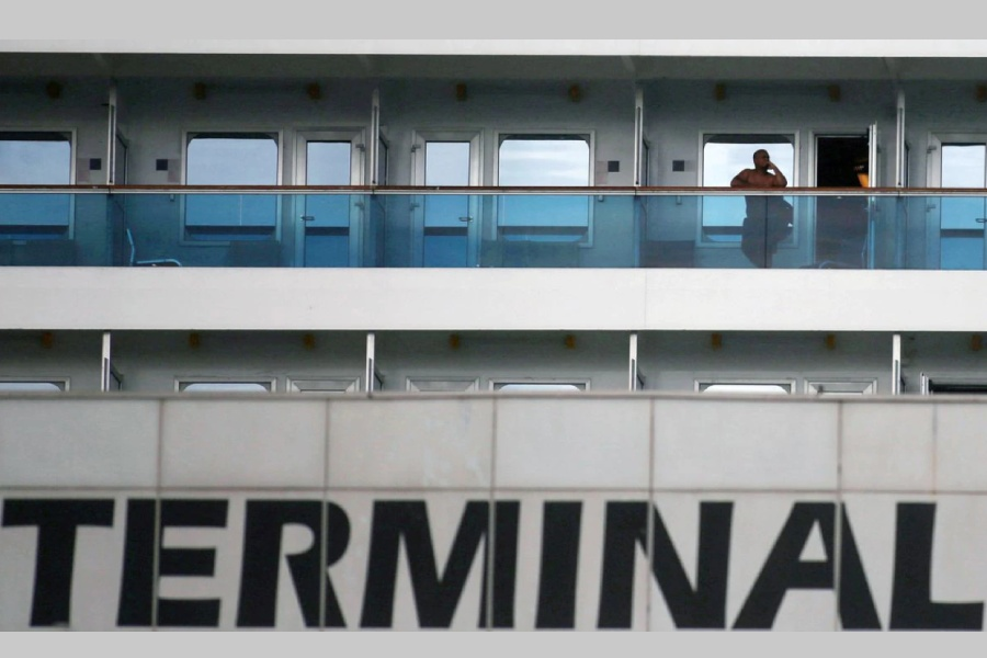 A passenger is seen on the balcony of the Costa Fascinosa cruise ship anchored at the Santos port, amid the coronavirus disease (COVID-19) outbreak, in Santos, Sao Paulo state, Brazil, March 30, 2020. REUTERS/Rahel Patrasso