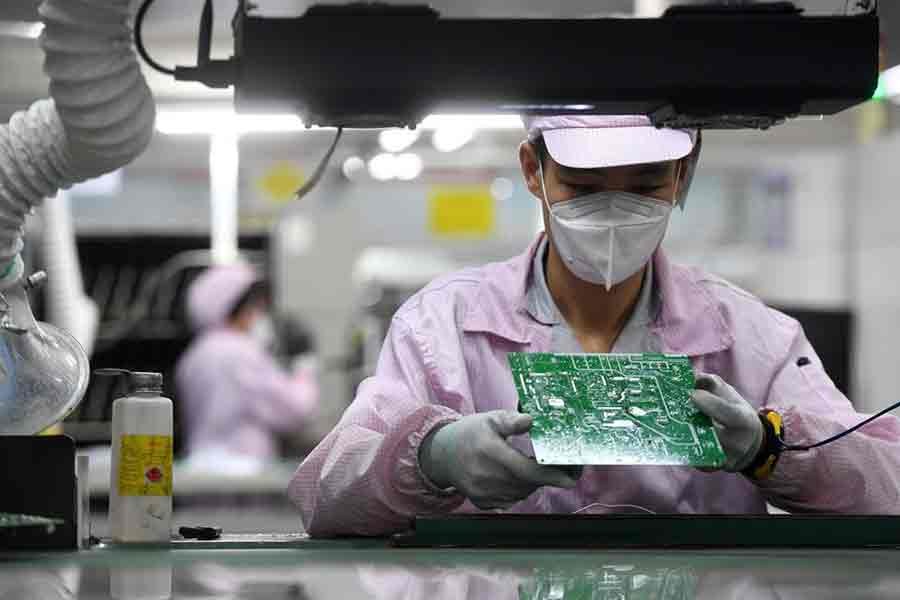 An employee inspecting a circuit board on the controller production line at a Gree factory in Wuhan under Hubei province of China on August 16 last year -Reuters file photo