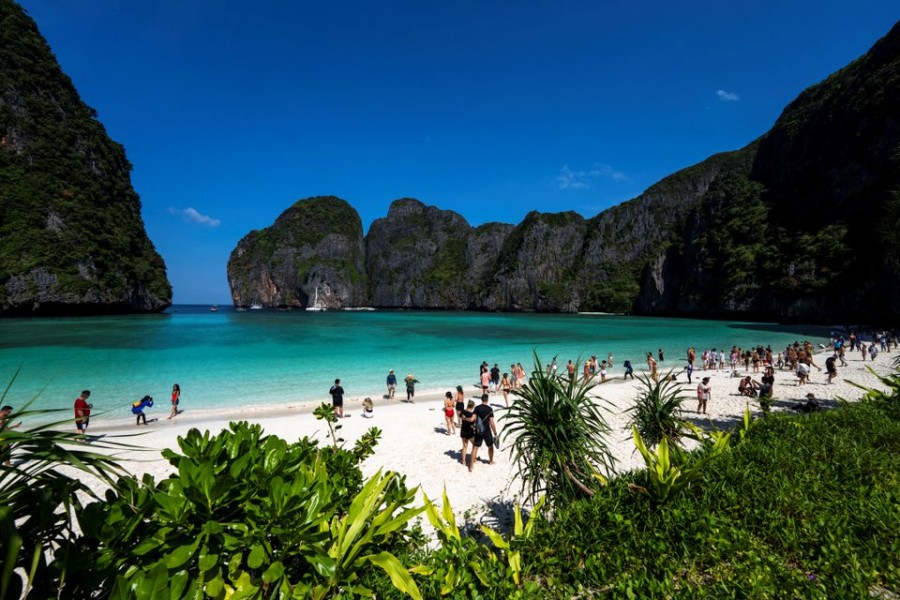 Tourists visit Maya bay after Thailand reopened its world-famous beach after closing it for more than three years to allow its ecosystem to recover from the impact of overtourism, at Krabi province, Thailand, January 3, 2022. REUTERS/Athit Perawongmetha