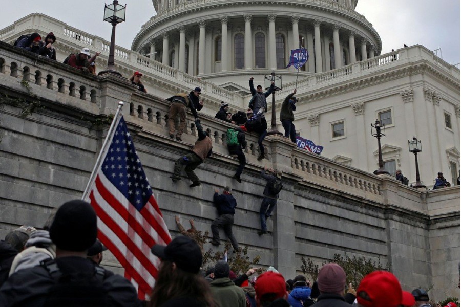 Supporters of US President Donald Trump climb a wall during a protest against the certification of the 2020 presidential election results by the Congress, at the Capitol in Washington, US, January 6, 2021. Picture taken January 6, 2021. REUTERS/Jim Urquhart