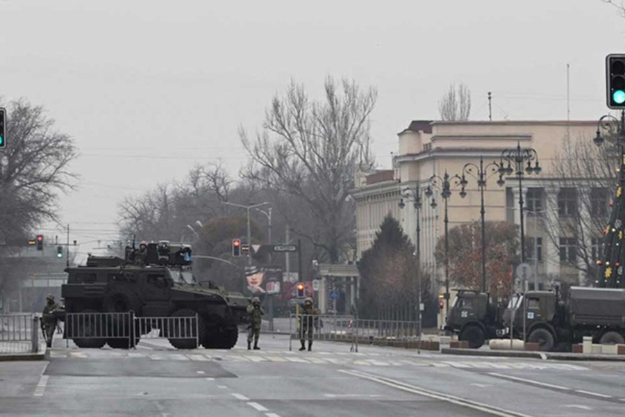 Kazakh service members stand guard at a checkpoint following the protests triggered by fuel price increase in Almaty, Kazakhstan Jan 7, 2022. Reuters