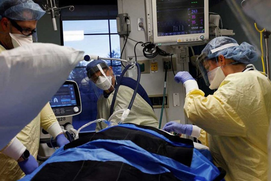 Medical staff treat a coronavirus disease (COVID-19) patient in their isolation room on the Intensive Care Unit (ICU) at Western Reserve Hospital in Cuyahoga Falls, Ohio, US, Jan 4, 2022. REUTERS/Shannon Stapleton