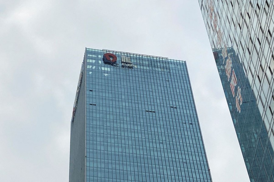 A partially removed company logo of China Evergrande Group is seen on the facade of its headquarters in Shenzhen, Guangdong province, China January 10, 2022. REUTERS/David Kirton