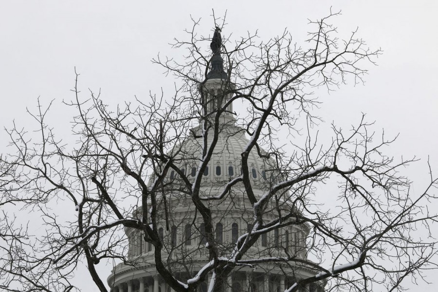 The Capitol Building is seen before a snow-covered tree on the eve of the first anniversary of the January 6, 2021 attack on the US Capitol, on Capitol Hill in Washington, US, January 5, 2022. REUTERS/Tom Brenner