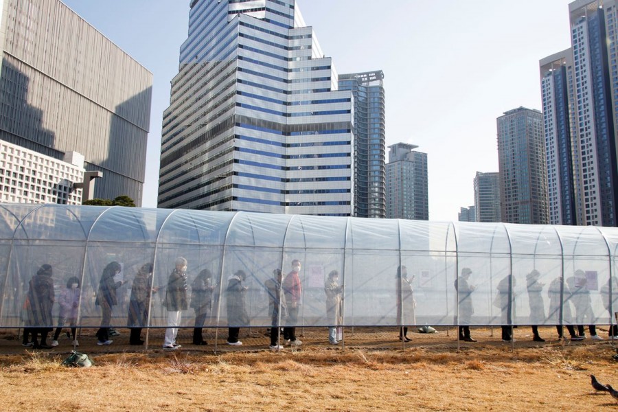 People wait in a line to undergo coronavirus disease (COVID-19) testing at a temporary testing site set up at a railway station in Seoul, South Korea, December 8, 2021. REUTERS/Heo Ran