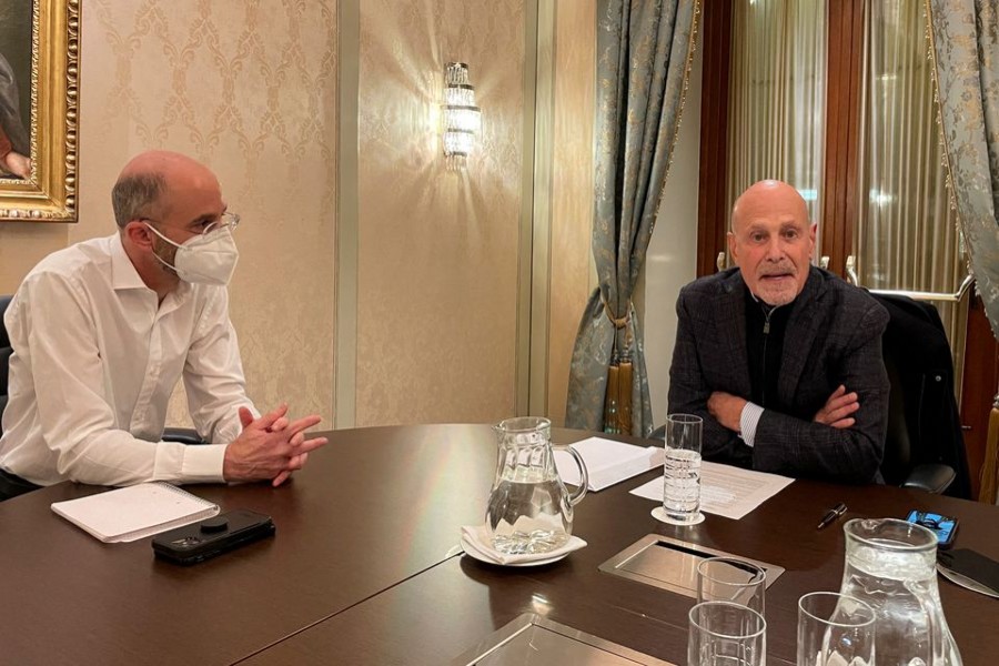 US Special Envoy for Iran Robert Malley and Barry Rosen, campaigning for the release of hostages imprisoned by Iran, sit at a table during an interview with Reuters in Vienna, Austria, January 23, 2022. REUTERS/Francois Murphy