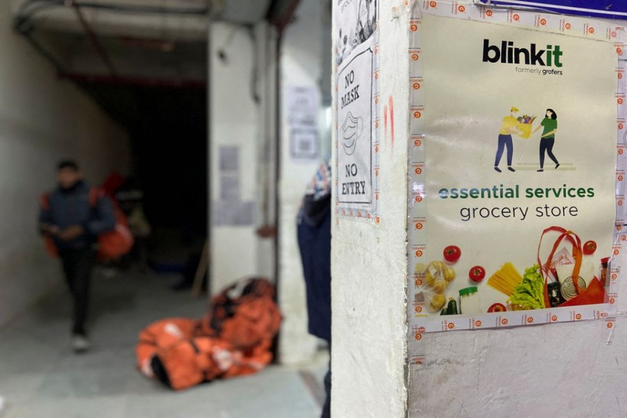 A delivery person leaves a dark store of the SoftBank-funded Blinkit, an Indian company which is offering 10 minute deliveries for groceries, in New Delhi, India, January 19, 2022. Picture taken on January 19, 2022. REUTERS/Anushree Fadnavis