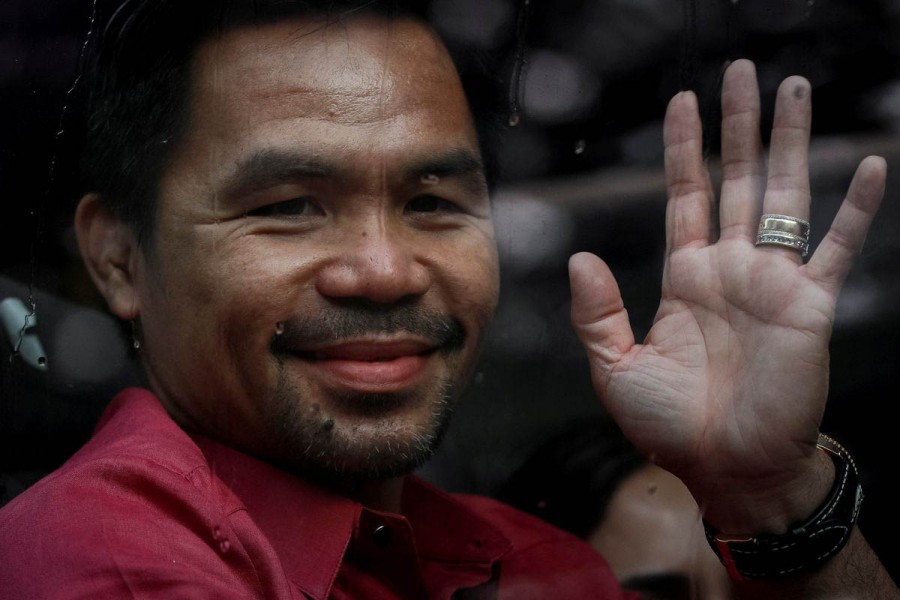 Philippine senator and newly retired boxing icon Manny Pacquiao waves to his supporters as he arrives at Sofitel Hotel to file his certificate of candidacy for president, in Pasay City, Metro Manila, Philippines, October 1, 2021 – Reuters/Eloisa Lopez