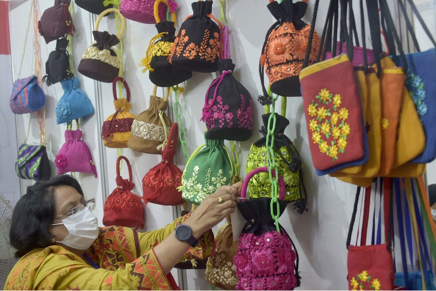 A visitor selects products at a stall during Bangladesh's National Small and Medium Enterprise (SME) Fair in Dhaka, capital of Bangladesh, on Dec. 5, 2021. 	— Xinhua Photo