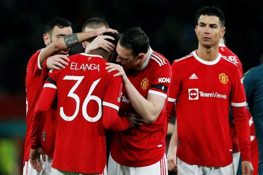 Football - FA Cup Fourth Round - Manchester United v Middlesbrough - Old Trafford, Manchester, Britain - Feb 4, 2022 Manchester United's Anthony Elanga is consoled by teammates after missing his penalty during the shoot-out – Reuters