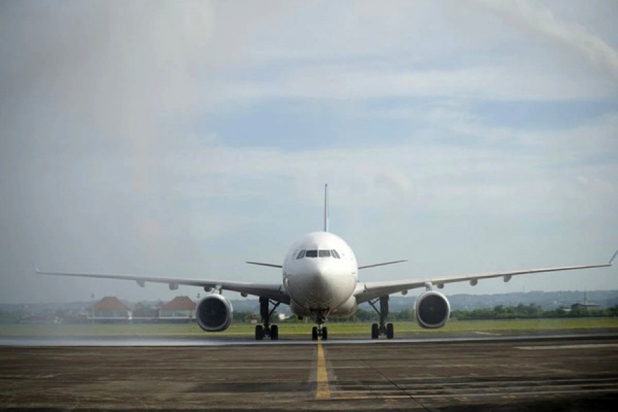 Garuda Indonesia aircraft flight GA881 carrying passengers from Narita, Japan, is sprayed with water upon its arrival at I Gusti Ngurah Rai International airport, as Bali welcomes its first direct flight carrying foreign tourists in nearly two years, after it was closed for foreign visitors due to the coronavirus disease (COVID-19) pandemic, in Badung, Bali, Indonesia February 3, 2022 – Courtesy of Garuda Indonesia via Reuters