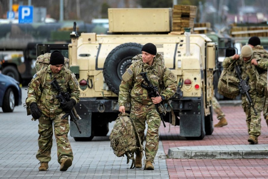 US soldiers from the 82nd Airborne Division walk near the G2A Arena following their arrival at Rzeszow-Jasionka Airport, in Jasionka, Poland on February 8, 2022 — Patryk Ogorzalek/Agencja Wyborcza.pl via REUTERS
