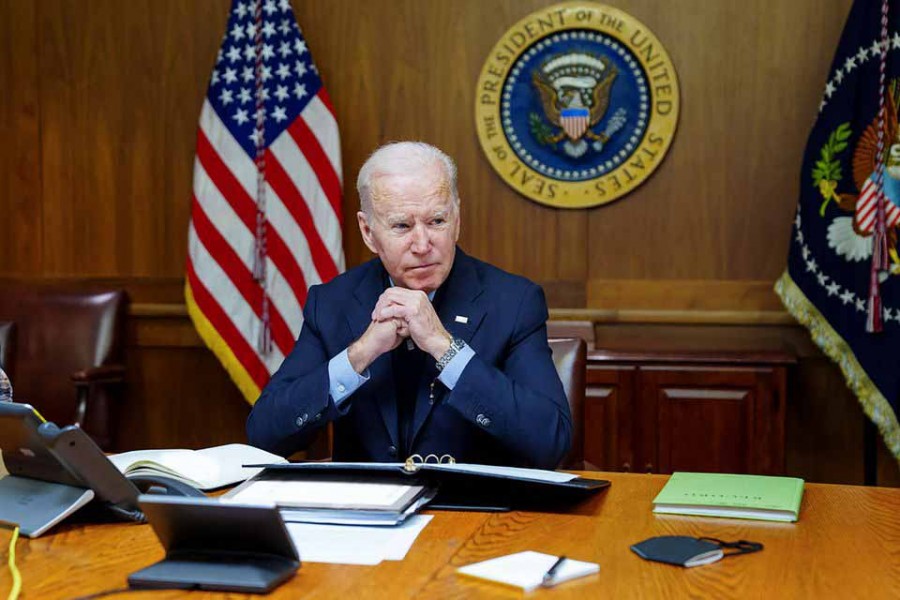 US President Joe Biden speaks on the phone with Russia's President Vladimir Putin about a possible Russian invasion of Ukraine, as Biden spends the weekend at the US presidential retreat at Camp David, in this official White House handout photo released after the call took place in Thurmont, Maryland, US, February 12, 2022 — The White House/Handout via Reuters